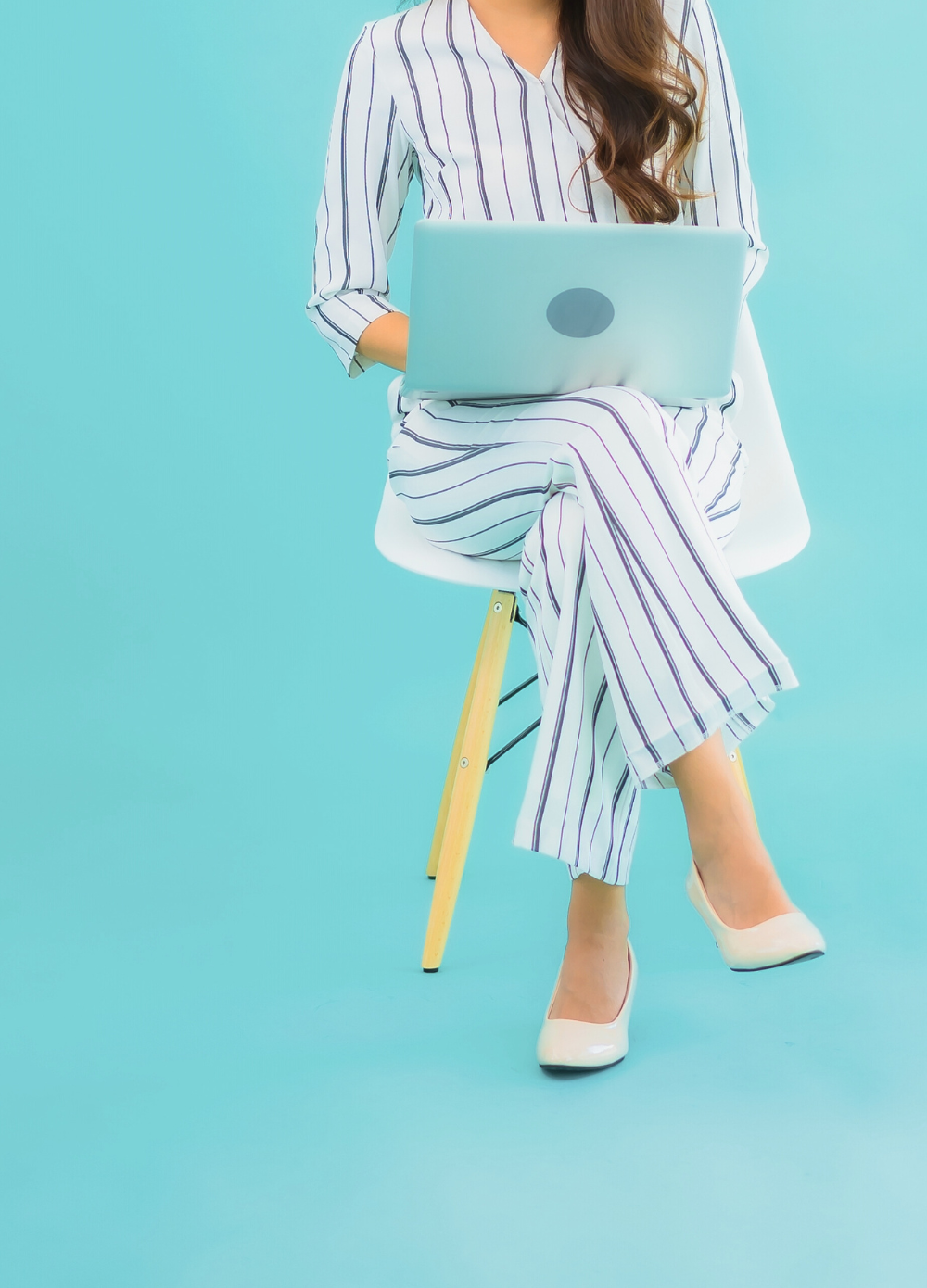 magtyne image_person sitting on yellow chair_typing on laptop