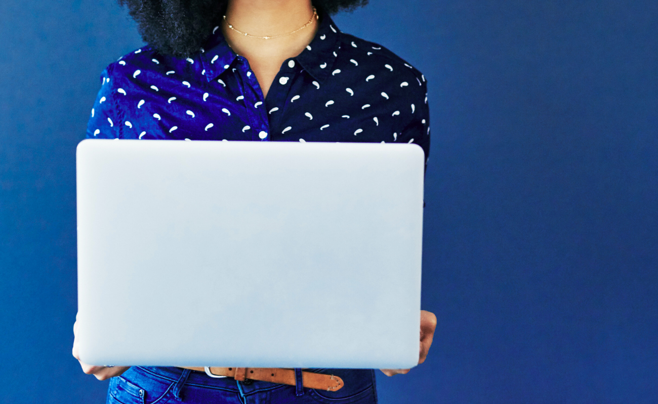 Strategic brand positioning and messaging services that define identity and drive engagement. Stack of colorful books on an orange surface, symbolizing brand standards and guidelines that ensure consistency in messaging and visuals as brands grow.