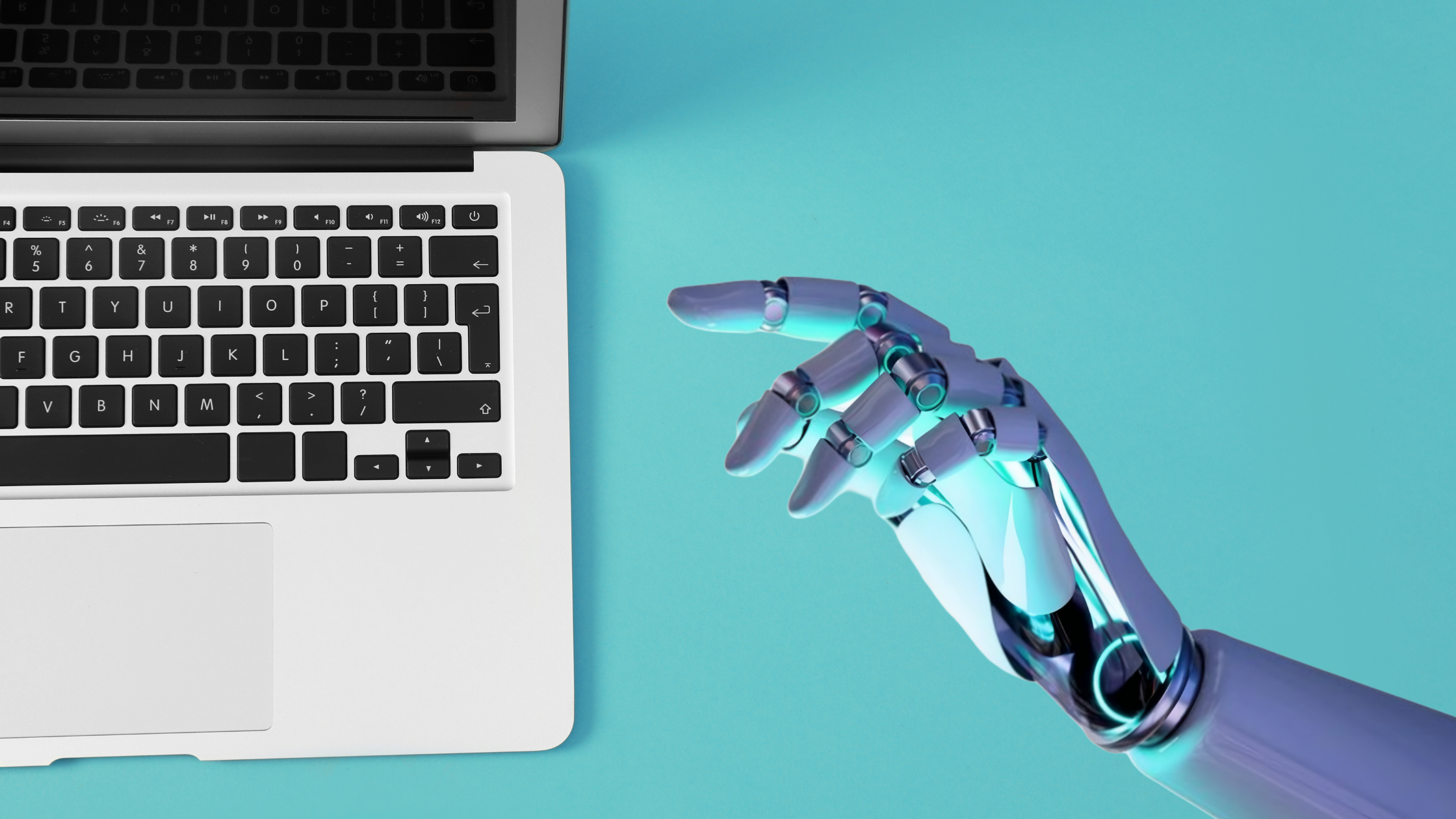 blog image_magtyne_artificial intelligence_ai A metallic robotic hand pointing toward a laptop keyboard against a teal background.
